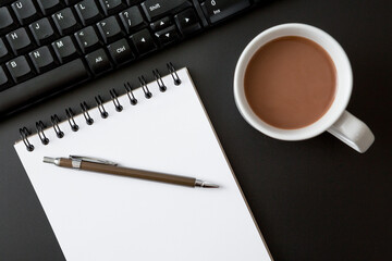 Notebooks , pen , coffee cup and Keyboard computer  on black background
