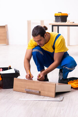 Young male carpenter working indoors