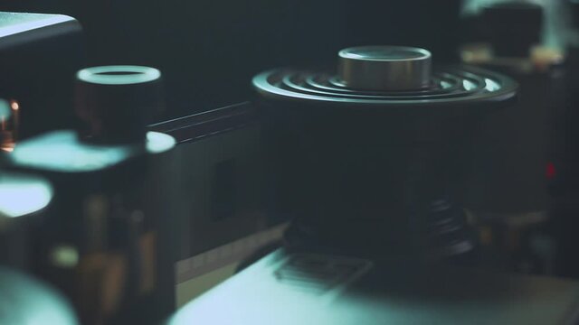 Old movie film strip. scanner is scanning 35 mm film to digital close up. Restoration of an old movie. History.