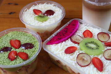 fruit salad of melon, grape, strawberry, kiwi dressed with natural yoghurt and sprinkled with chopped Apple