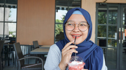 Asian woman is drink red velvet