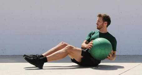 Medicine ball exercise - man doing russian twist in abs workout. - Powered by Adobe