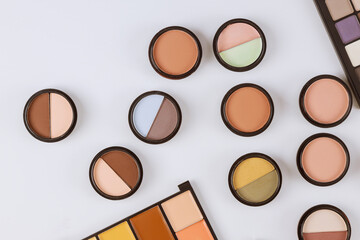 Set of eyeshadows in pastel beige colors pallet brown matte shadows, closeup of makeup product on an isolated white background - obrazy, fototapety, plakaty