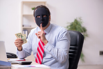 Male employee with mask in hipocrisy concept