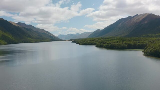 AERIAL: Mavora Lakes and the river draining from them with forests and mountains around and a swing bridge. Mavora was used as a location in Lord of the Rings, LOTR. New Zealand, South Island.