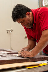 Man fixing a wood door