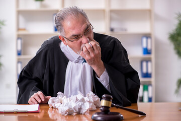 Old male judge working in courthouse