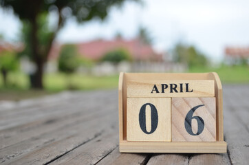 April 6, Number cube with a natural background.