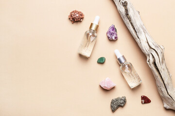 Cosmetic liquid gel products, natural semiprecious stones and old tree snag. Beauty skin care concept