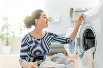 woman is doing laundry - obrazy, fototapety, plakaty