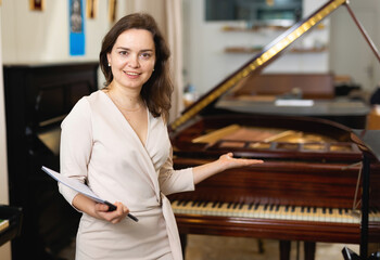 Female assistant or customer at piano music store. High quality photo
