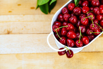 Ripe sweet cherries on a wooden background.