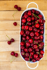 Ripe sweet cherries on a wooden background.