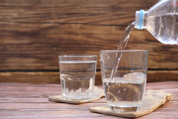 glass of water on wooden table
