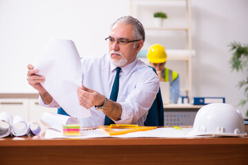 Two male architects working in the office