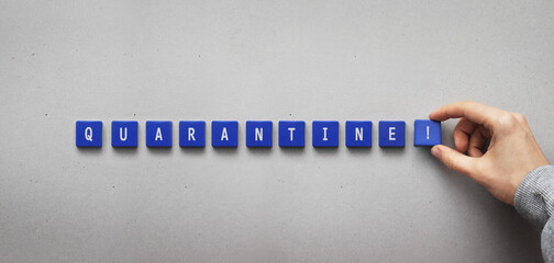 The word "quarantine" written on blue blocks. Isolation from the spread of the virus