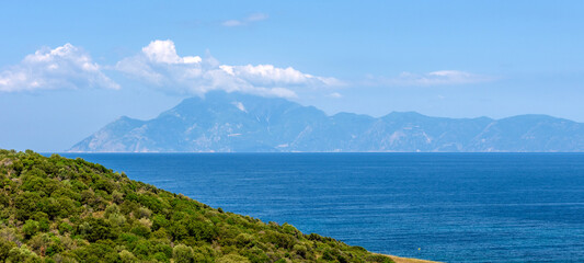 Fototapeta premium Landscape with sea, the rock and the beautiful clouds in the blue sky