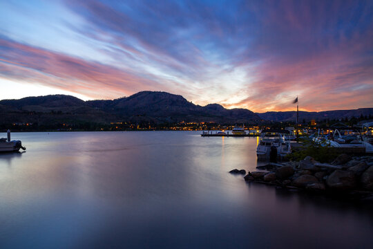 Dawn over Chelan Lake in Washington. Colorful sky reflects in calm water