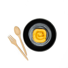 wooden spoon and black plate with a Jam Rolls