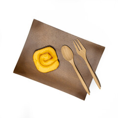 wooden spoon and plate with a Jam Rolls