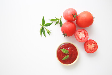 Fototapeta premium Bowl of ketchup or tomatoes sauce with ingredients on white background.