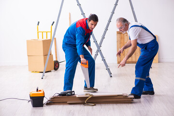 Two contractors and snake indoors