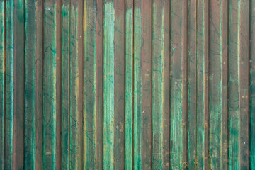 Fototapeta na wymiar Old green metal vertical panels texture closeup