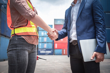 Businessman and Container Shipping Worker Handshake Together for Cooperation Shipment in Logistic...