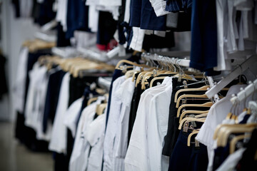 School clothes for boy and girl on hanger.