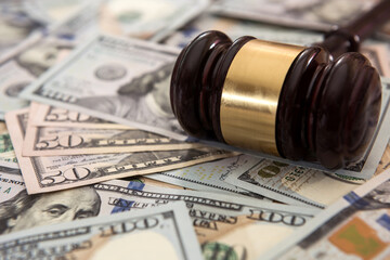Wooden gavel and dollar bills in justice concept