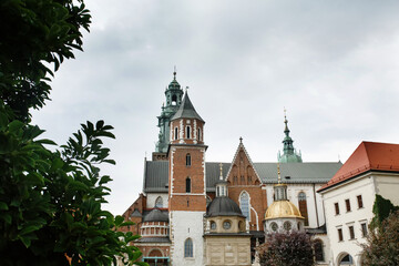 Fototapeta premium Cathedral and towers of Wawel castle residency in park landscape in Krakow, Poland