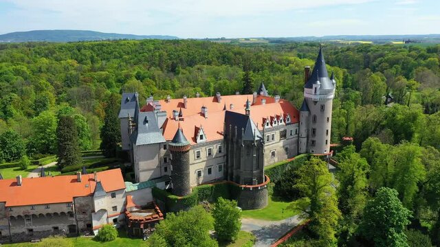 Aerial view of Zleby castle in Central Bohemian region, Czech Republic. The original Zleby castle was rebuilt in Neo-Gothic style of the chateau. Chateau Zleby, Czechia.