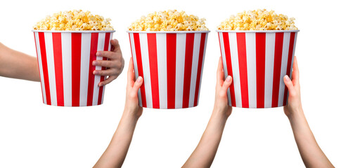 Woman hand holding striped bucket with popcorn isolated on white background © Vasyl Onyskiv