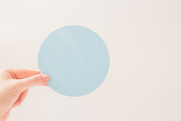 Paper circles, round blue cardboard mock up in hand. Blank template. Empty mockups of tags. Layout bank interest on loan