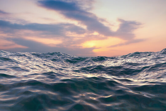 Closeup surface of wavy ocean blue sea water with sunset and red clouds behind. Abstract Background Texture.