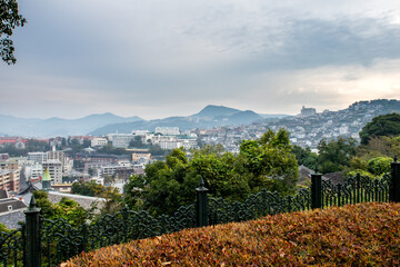 NAGASAKI, Japan. Nagasaki landscape view with autumn trees and overcast sky seen from Glover Garden...