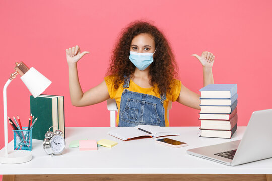 African American Girl In Sterile Face Mask Employee In Office Sit Isolated On Pink Background. Achievement Business Career. Education In School University College Concept. Pointing Thumbs On Herself.