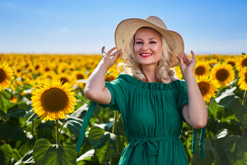 Young beautiful woman in a sunflower field