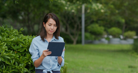 Fototapeta premium Woman look at tablet computer at outdoor