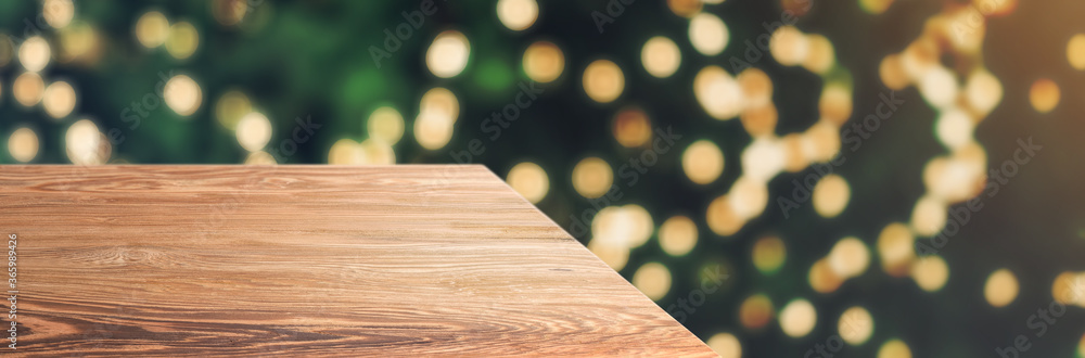 Aufkleber wooden table top with abstract blur christmas tree with string light background with bokeh light,winter Holiday backdrop,Mock up banner for display of product
