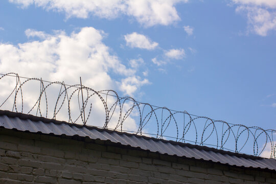 Prison wall with barbed wire.