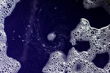 White tiny bubbles on deep blue color water wallpaper background