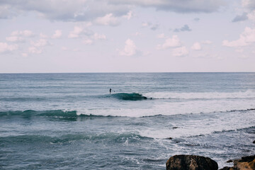 Blue sea with waves surfer floats in the distance. Sup board  