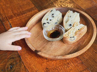 Freshly baked sliced bread on rustic wooden background.