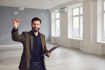 Realtor agent is a realtor with keys in hand against the background of a white real estate room...
