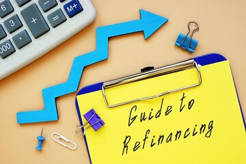 Financial concept meaning Guide To Refinancing with sign on the sheet.