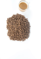 heap of coffee beans with coffee cup from top view.
