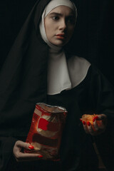 
Beautiful girl nun, eating chips, squeezes them in his hand.