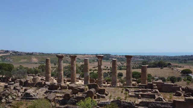 Ruins Of The Historical Temple Of Juno At The Valley Of The Temples In Agrigento, Sicily, Italy - low drone shot