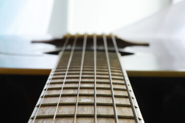 An acoustic guitar for an artist playing a stringed musical instrument on stage. Black guitar with...